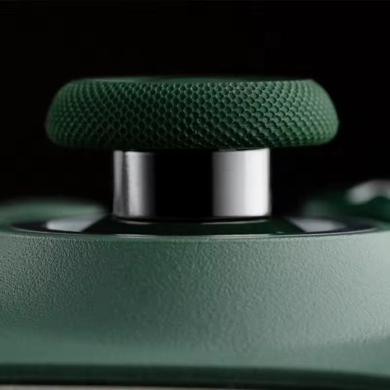 Macro close‑up of a green textured joystick from a gaming controller, showing fine grip pattern and metallic shaft with matte green housing, emphasizing premium build quality and tactile precision.