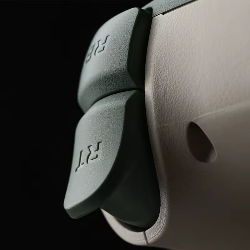 Macro close‑up of a gaming controller’s right trigger (RT) and right bumper (RB) buttons in matte green and beige tones, highlighting ergonomic curvature, textured finish, and premium build quality under soft lighting.