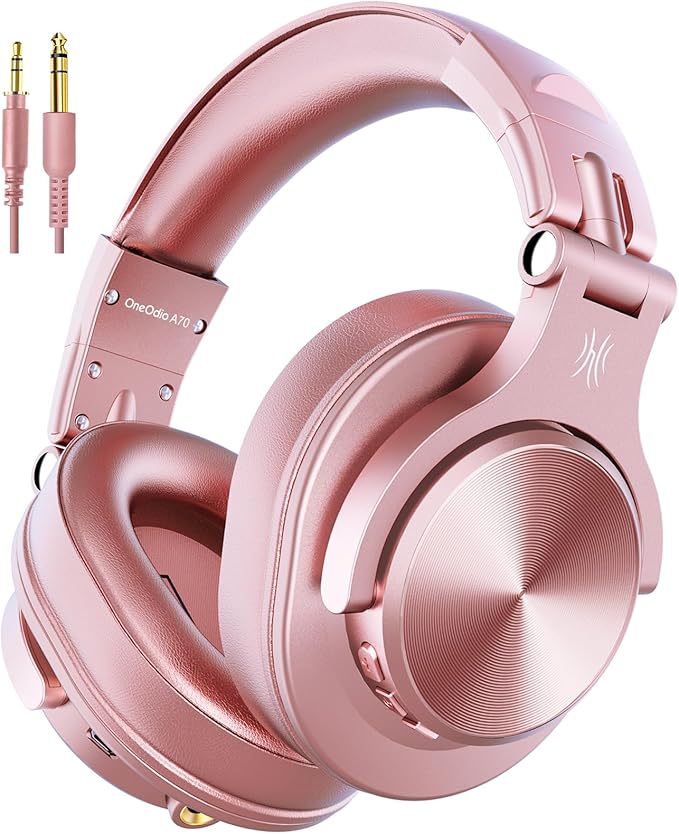 OneOdio Fusion A70 Rose Gold wireless DJ headphones featuring plush over-ear cushions, swiveling earcups, USB charging cable, 3.5mm audio lead, and 6.35mm jack connector.