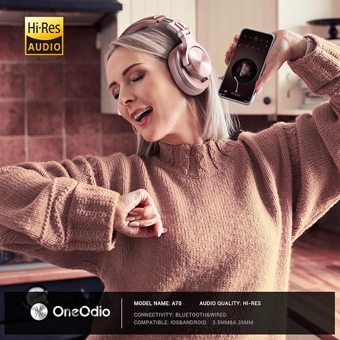Woman wearing pink headphones and holding a phone with Oneodio branding, in a kitchen setting.