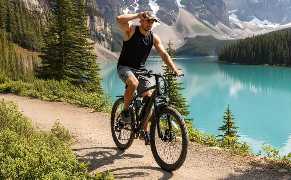 Scenic outdoor lifestyle shot of a rider navigating a mountain trail alongside a lake   