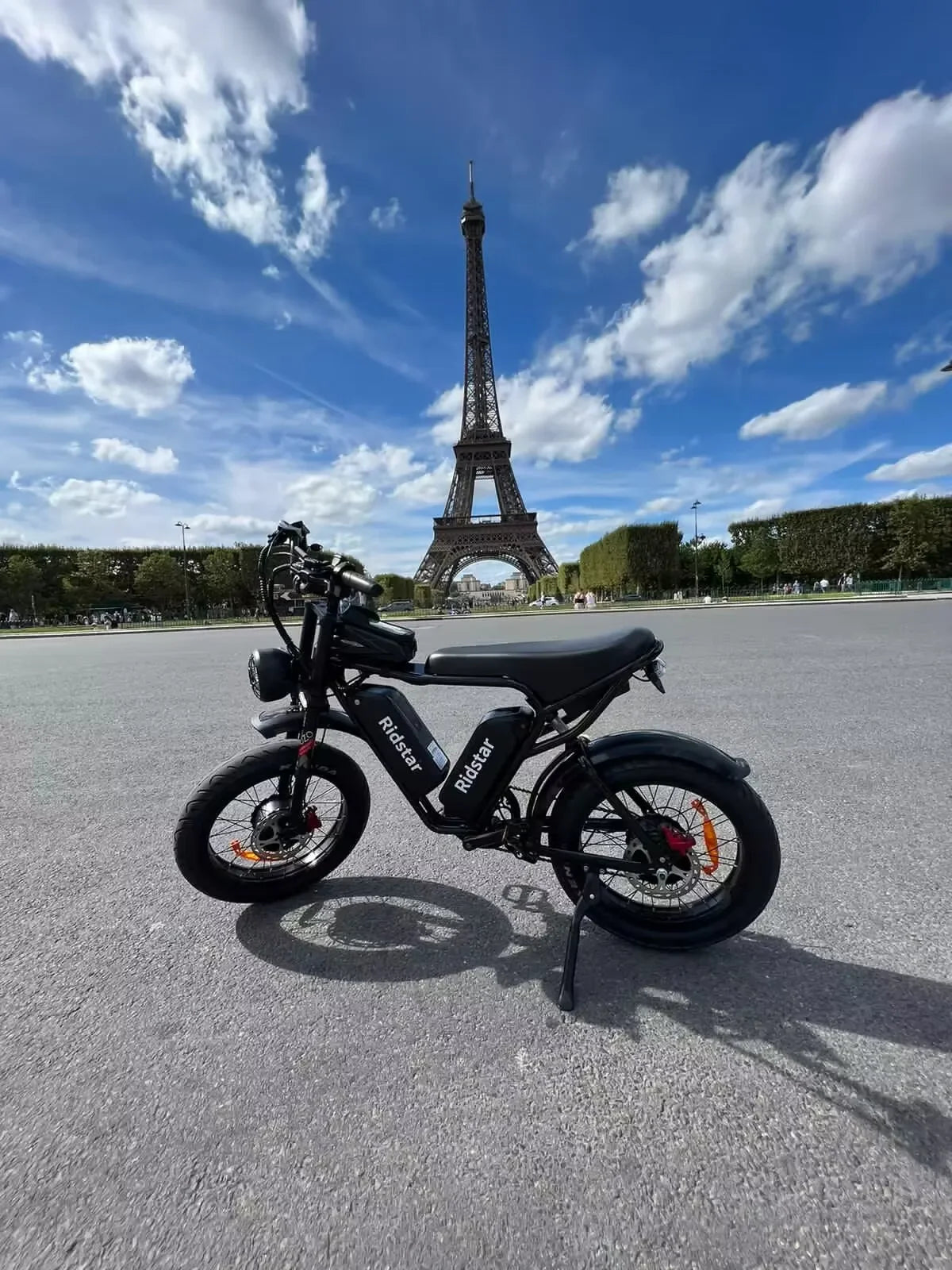 Black Electric bike in front of the Eiffel Tower on a clear day