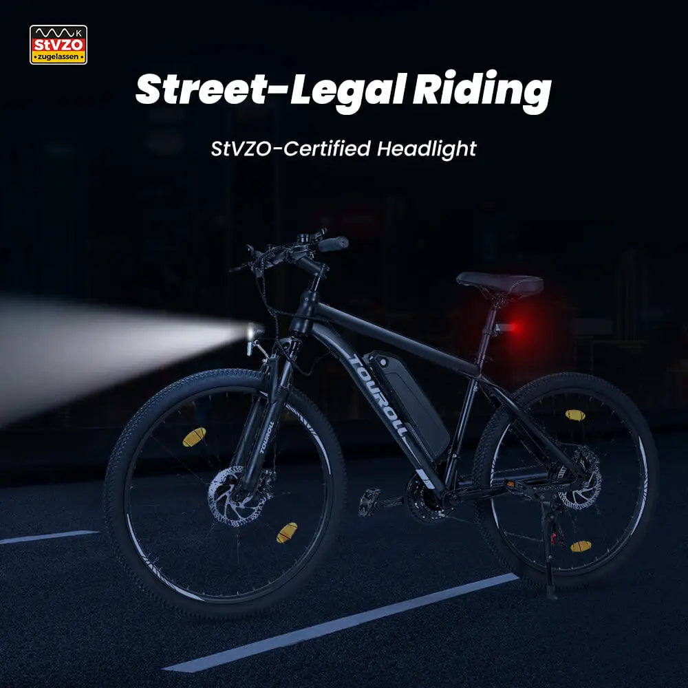 Electric Bicycle on a black background with a  StVZO-Certified headlight turned on shining brightly