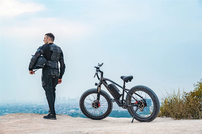 Person standing next to an electric bike on a scenic background