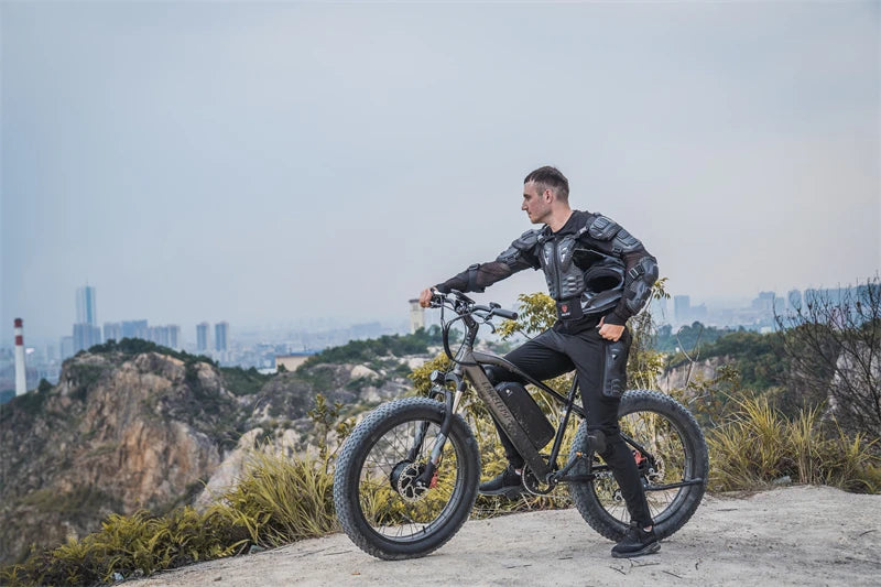 Person standing next to an electric bike on a scenic background with the city in the distance