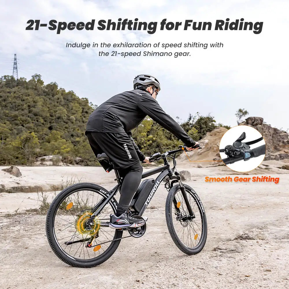 Person riding an electric bicycle with 21-speed shifting feature on a mountain trail.