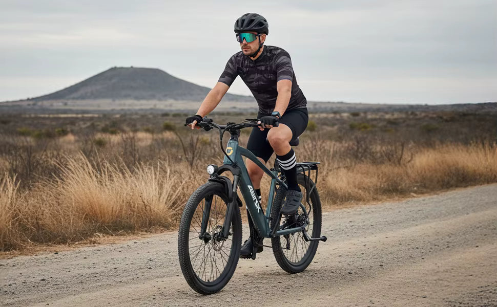 Lifestyle action photograph of a rider navigating a gravel path on the electric bike