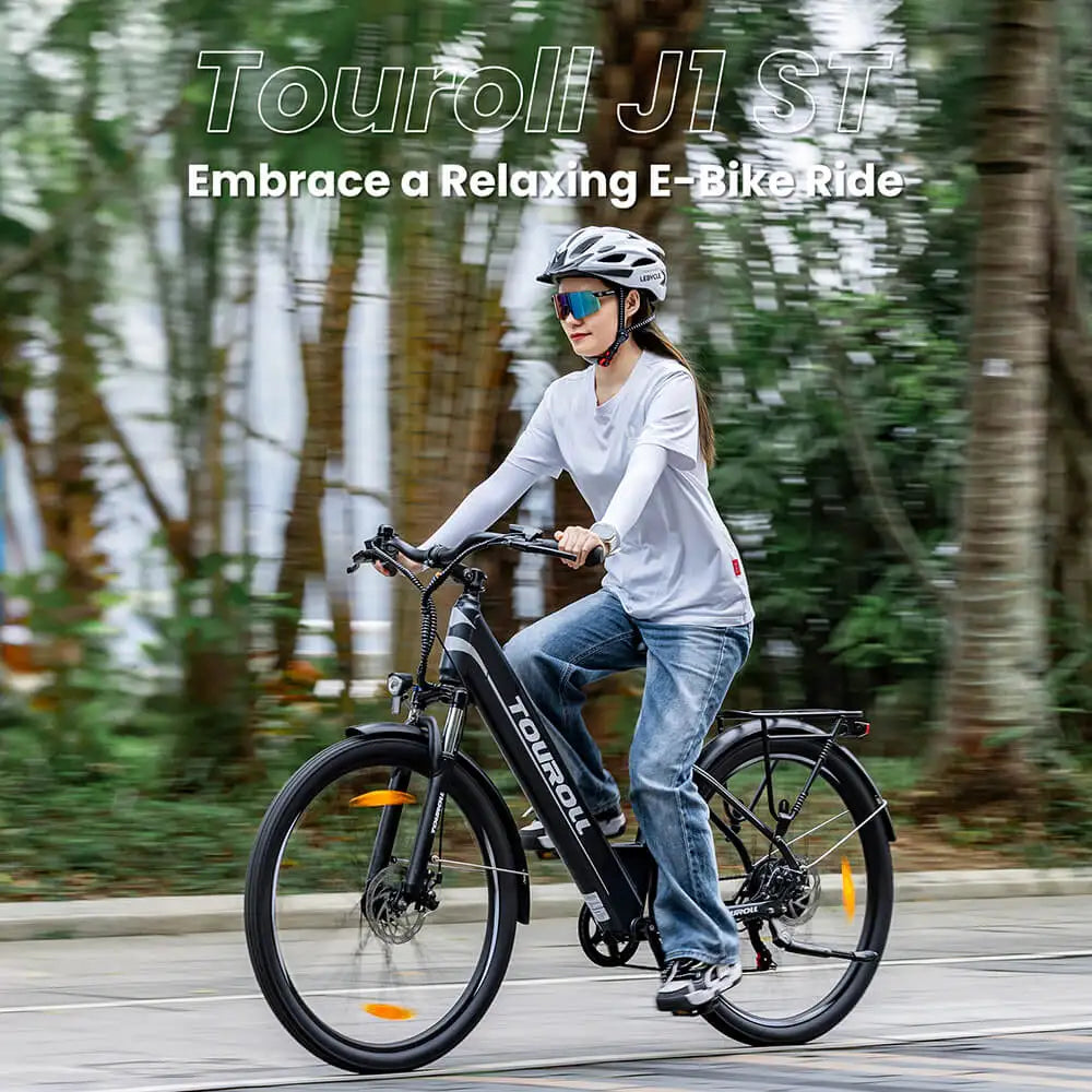 Person riding a Touroll J1 ST electric bike on a path with trees in the background