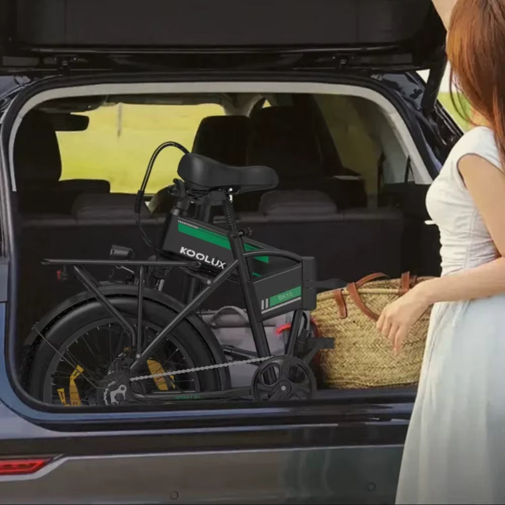 Woman loading an electric bicycle into the trunk of a car with a Koolux brand label.
