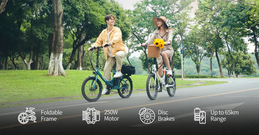 Two people riding electric bicycles on a path in a park with greenery.