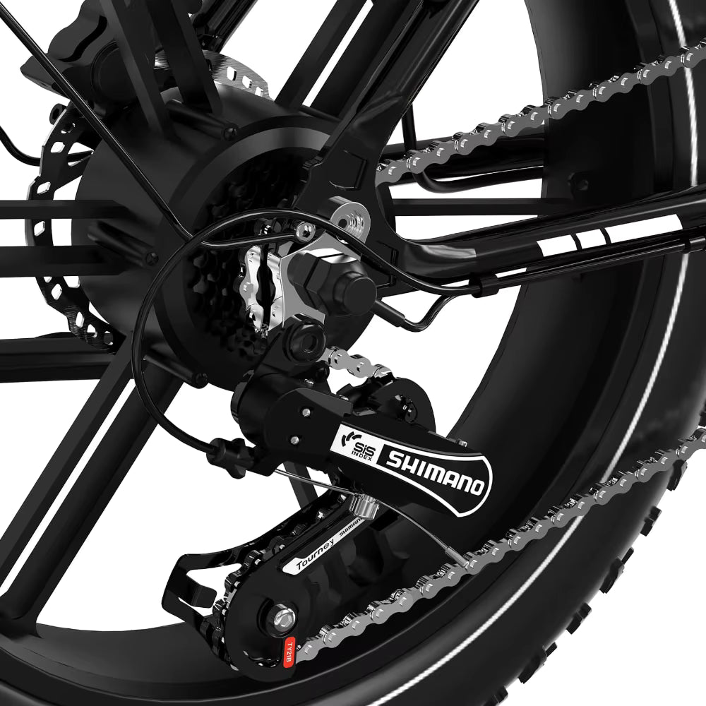 Close-up of a KOOLUX X11S electric bicycle chain and gear system with Shimano branding on a white background