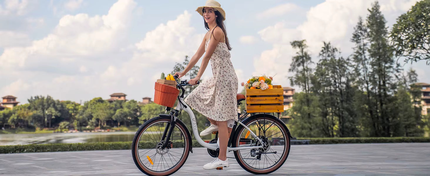 Woman riding a White DYU C6 Pro E-Bike electric bicycle with flower baskets in a park setting