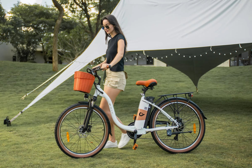 Woman with a White DYU C6 Pro E-Bike electric bicycle under a large white canopy in a park-like setting