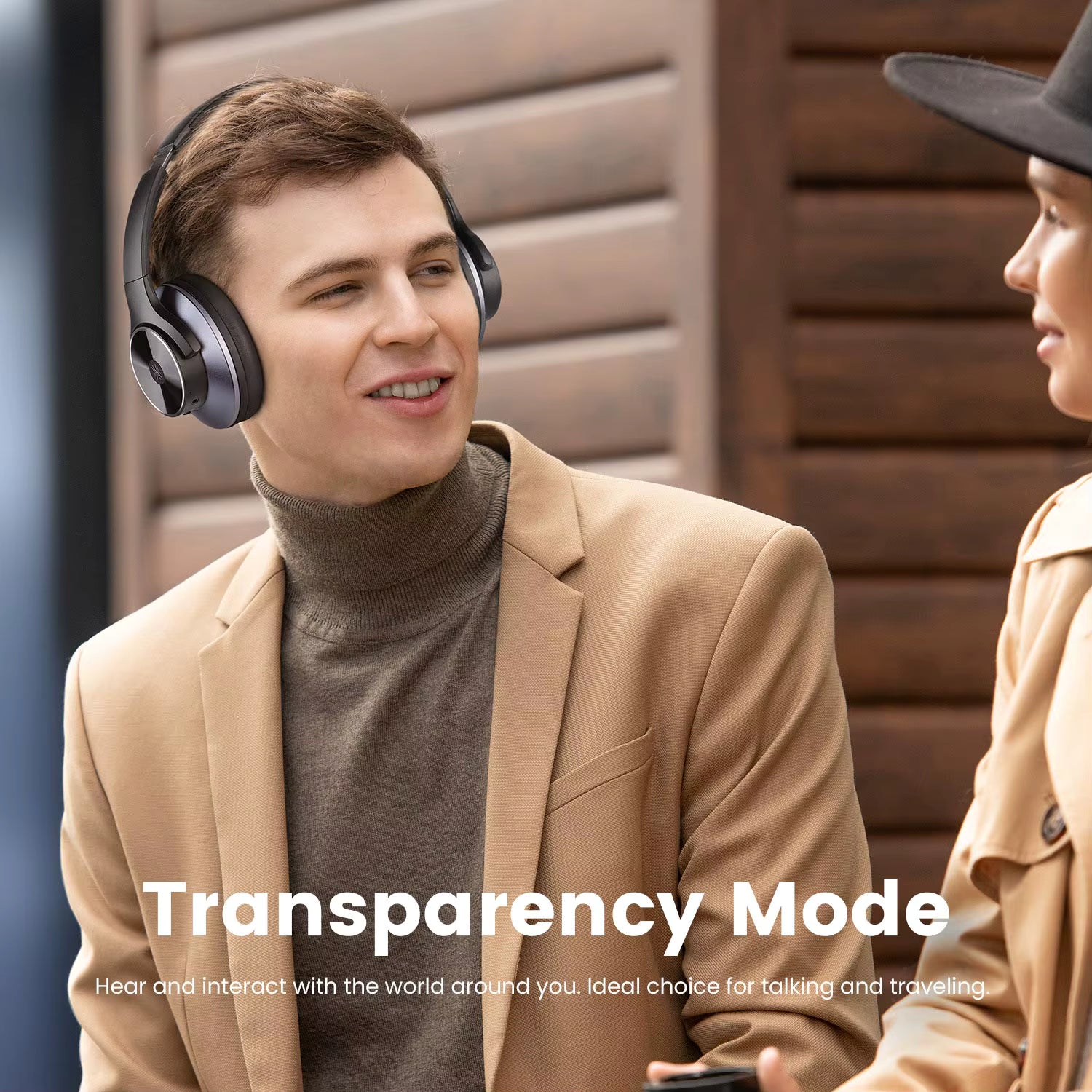 Two people wearing OneOdio A10 Hybrid ANC Over-Ear Bluetooth headphones with text 'Transparency Mode' on a wooden background