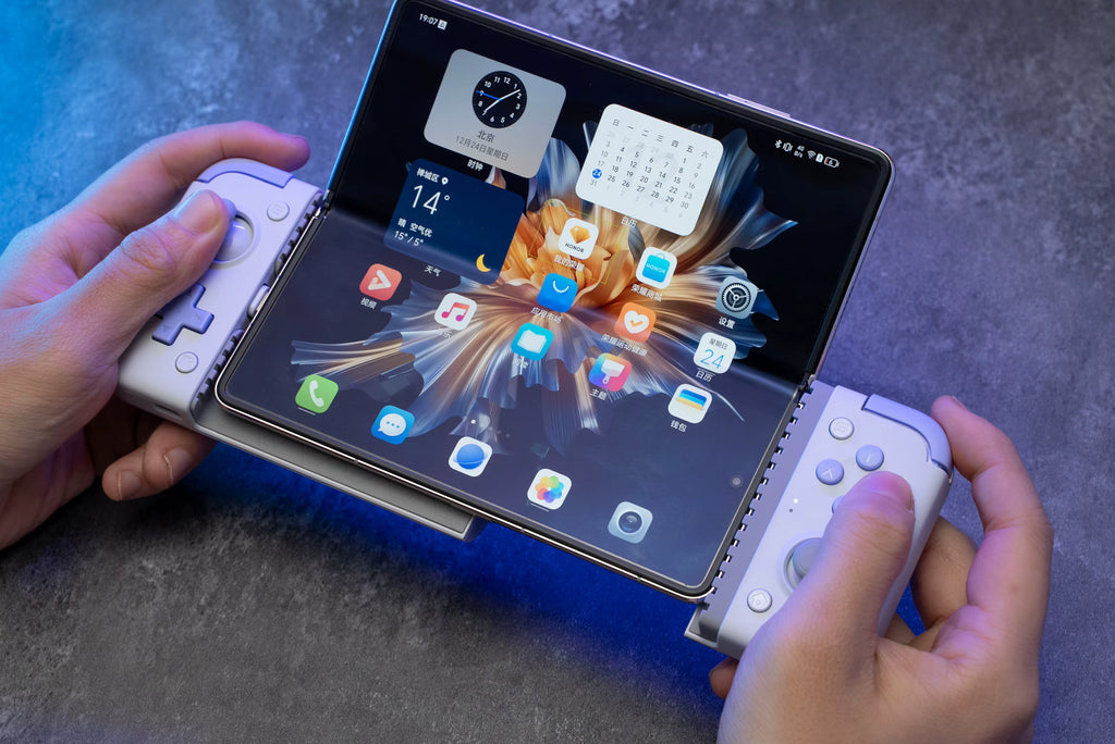 User playing a mobile game on a foldable tablet device using the GameSir X2s controller