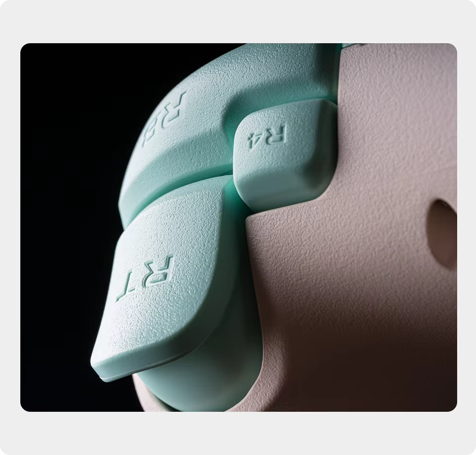 Close-up of light blue silicone buttons with 'RT' and 'R4' text on a black background