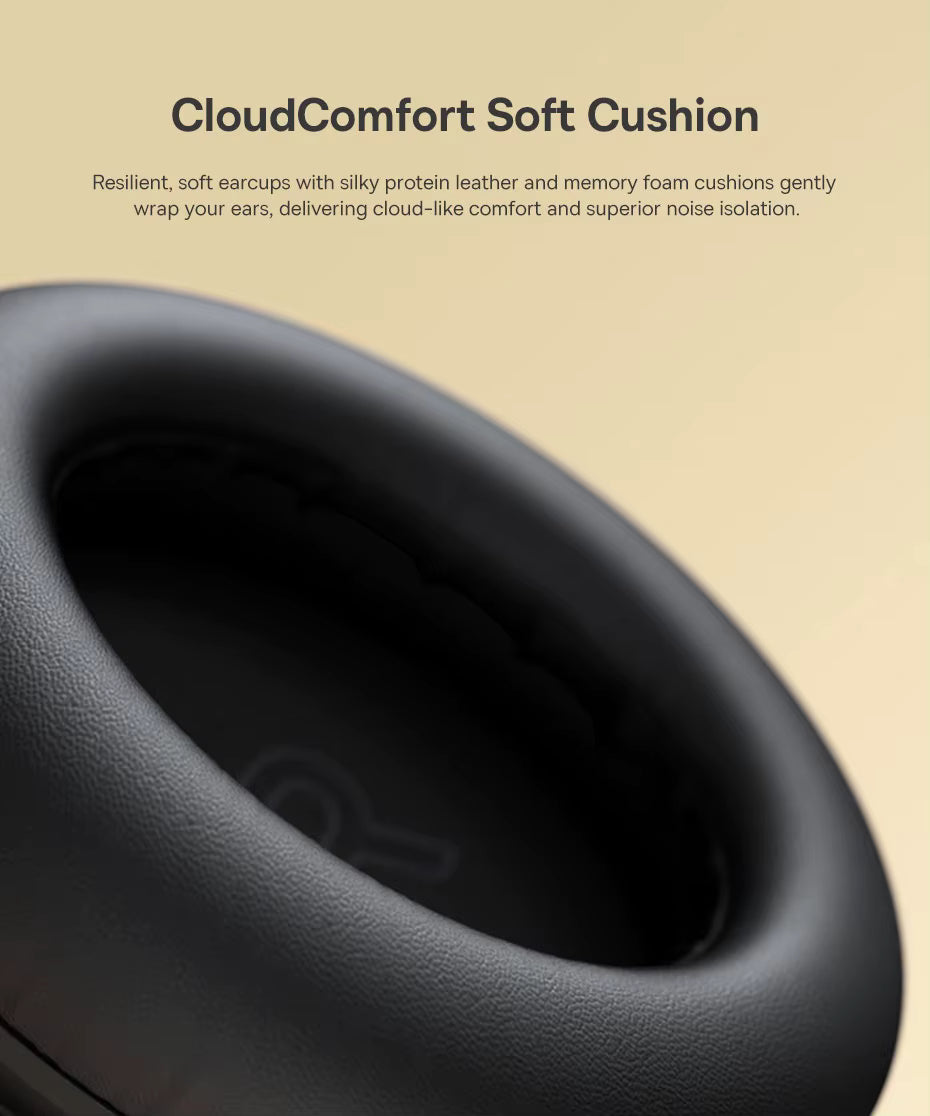Close‑up of a black headphone earcup showing soft protein leather and memory foam padding with the heading “CloudComfort Soft Cushion,” highlighting Baseus Bowie MH1’s resilient earcups designed for cloud‑like comfort and superior noise isolation.