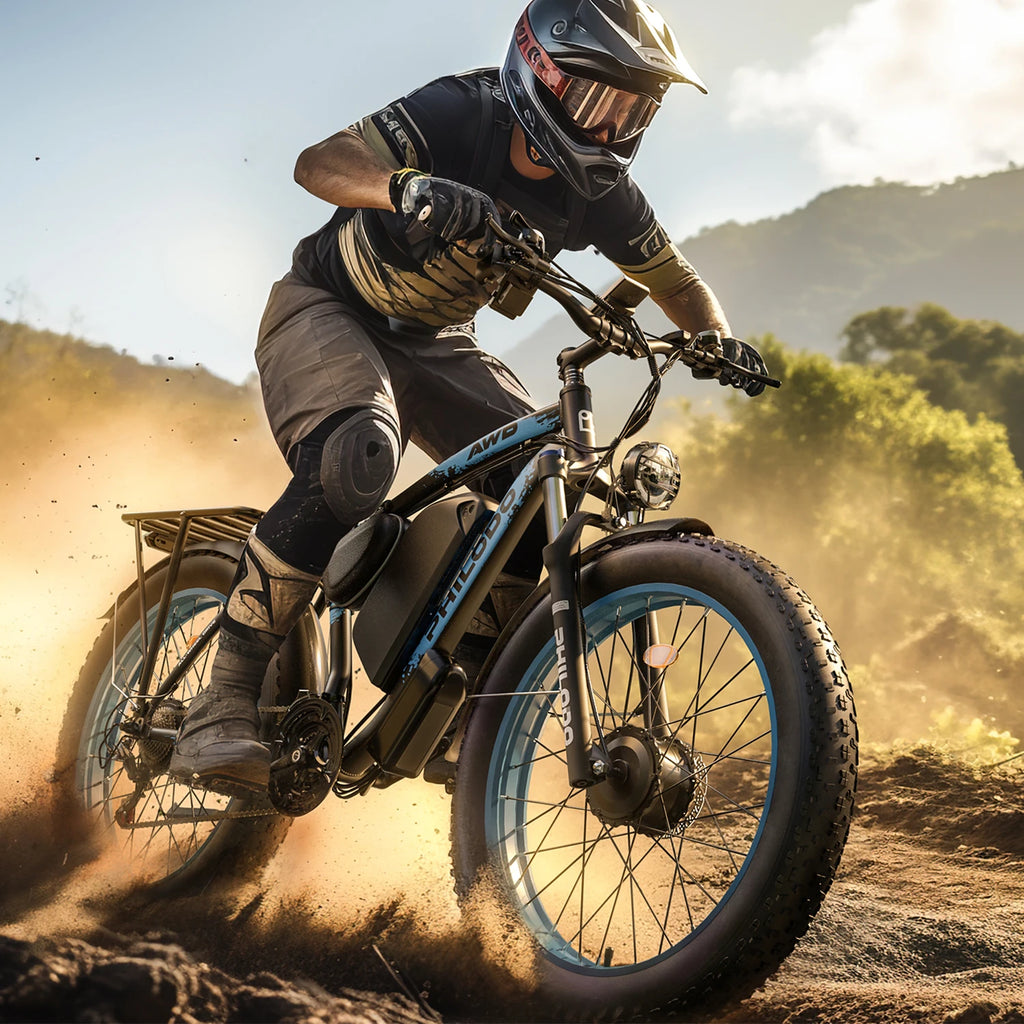 Person riding a fat-tire e-bike on a dirt trail with mountains in the background