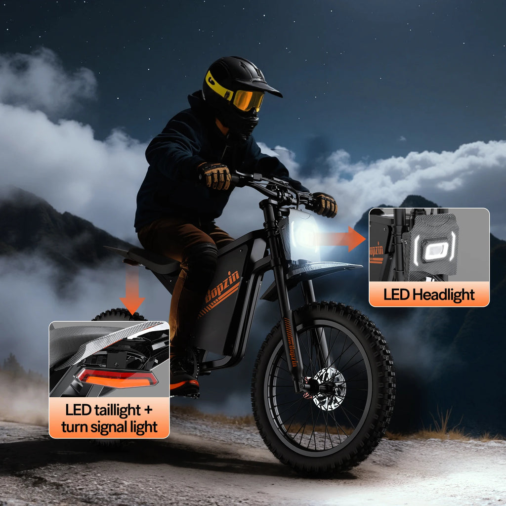 Person riding an electric dirt bike with LED headlight and tail light features highlighted against a mountainous background.