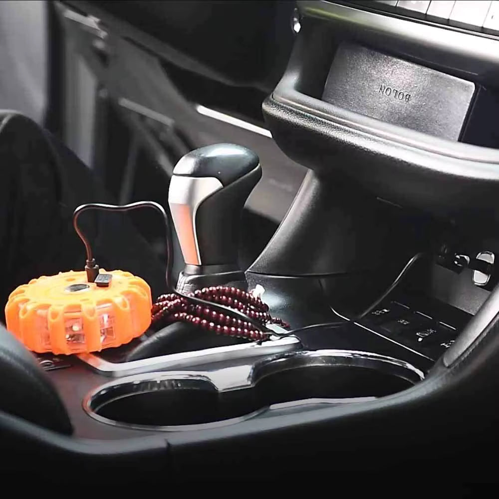 VARELO magnetic LED road flare stored compactly in a car center console for fast access during emergency breakdowns
