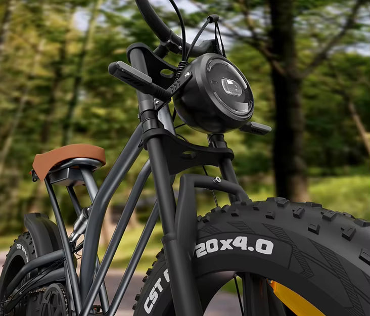 JANSNO X50 Black electric bike with large tires and a headlight in a natural setting