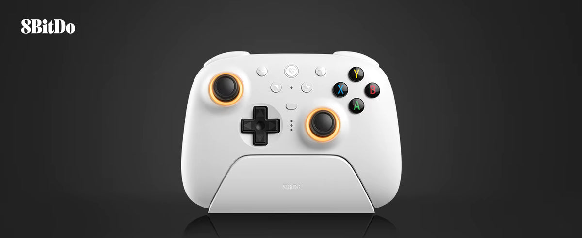 Studio product shot of the 8BitDo Ultimate 2 Wireless Controller in white, docked neatly on its magnetic charging stand against a clean dark grey background with the 8BitDo logo in the upper corner.