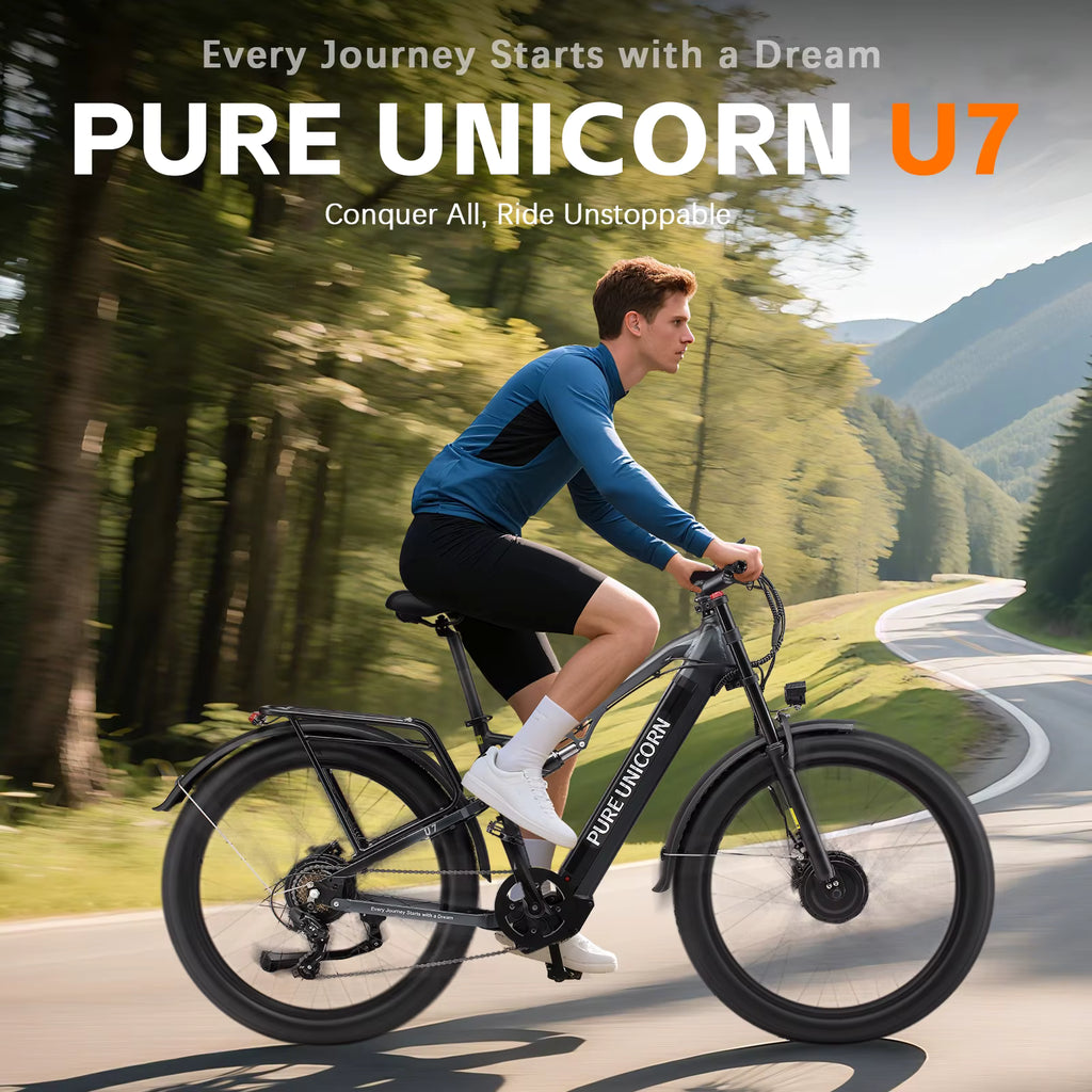 Person riding a Pure Unicorn U7 electric bike on a scenic road with trees and mountains in the background.