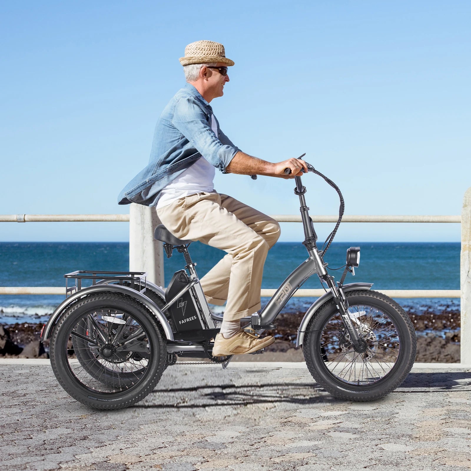 Man riding an electric tricycle by the sea on a sunny day