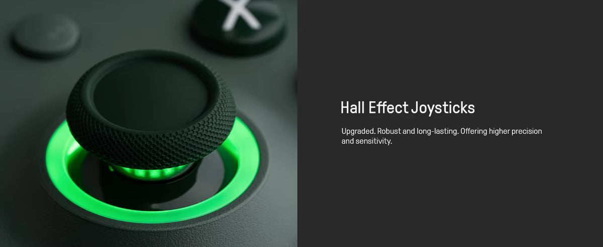 Close‑up of a black gaming controller joystick with textured grip and glowing green ring, highlighting Hall Effect technology for upgraded precision, durability, and sensitivity.