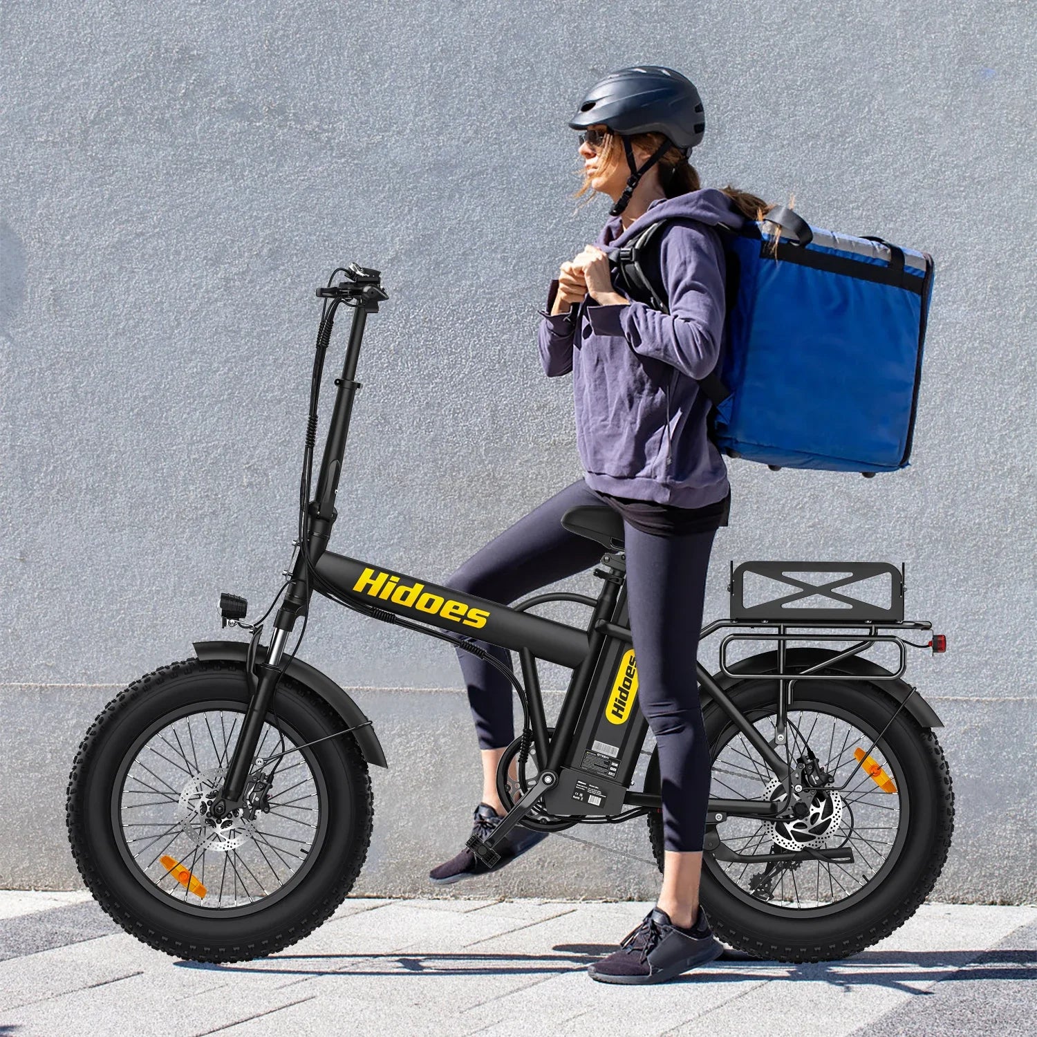 Person with a blue delivery bag on an black Hidoes  HD-F3PRO electric bike with 'Hidoes' branding.