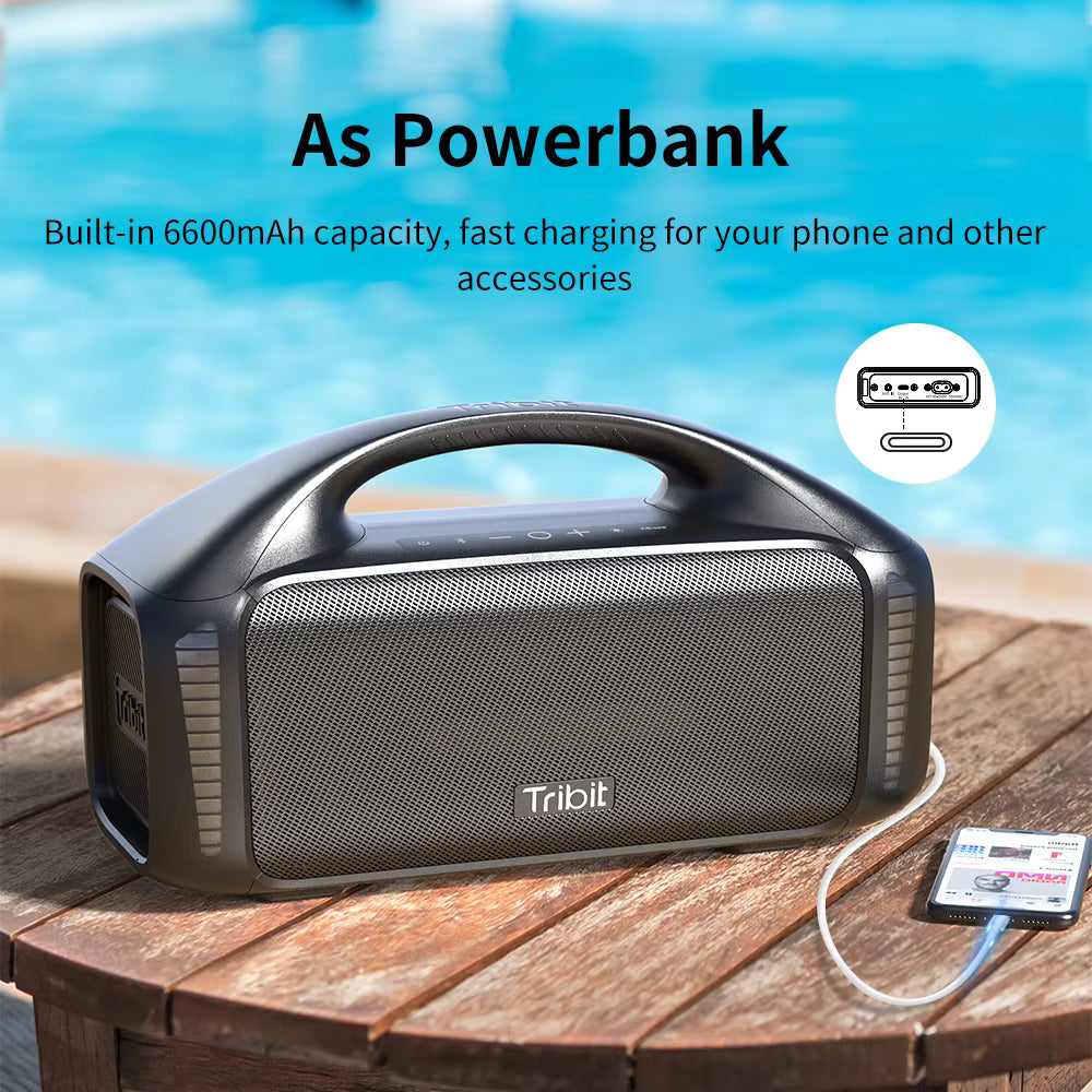 Tribit power bank with 6600mAh capacity on a wooden surface by a pool.