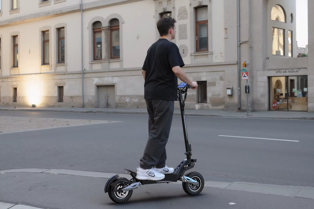 Person riding an electric scooter on a city street.