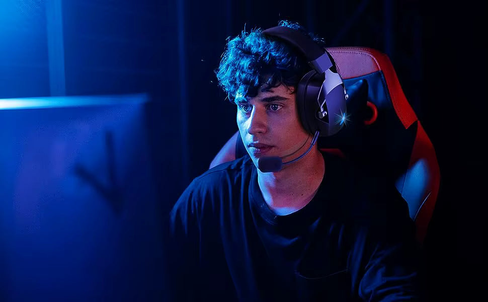 Lifestyle action shot of a gamer wearing the headset in a neon-lit setup