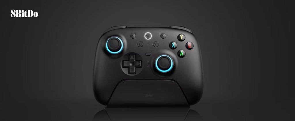 Studio product shot of the 8BitDo Ultimate 2 Wireless Controller in black, docked neatly on its magnetic charging stand against a clean dark grey background with the 8BitDo logo in the upper corner.