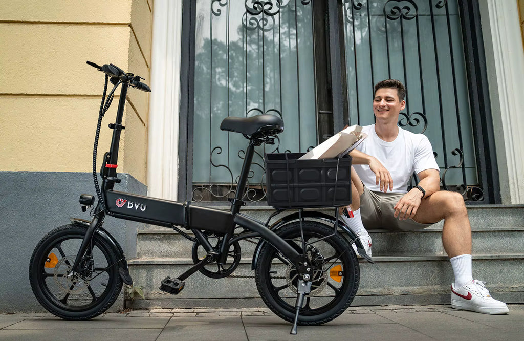 Man sitting on steps next to a black electric bike  DYU A1F Pro Folding E-Bike  with a basket.