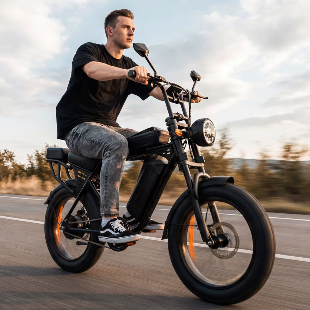 Man riding a black electric bike on a road with a blurred background
