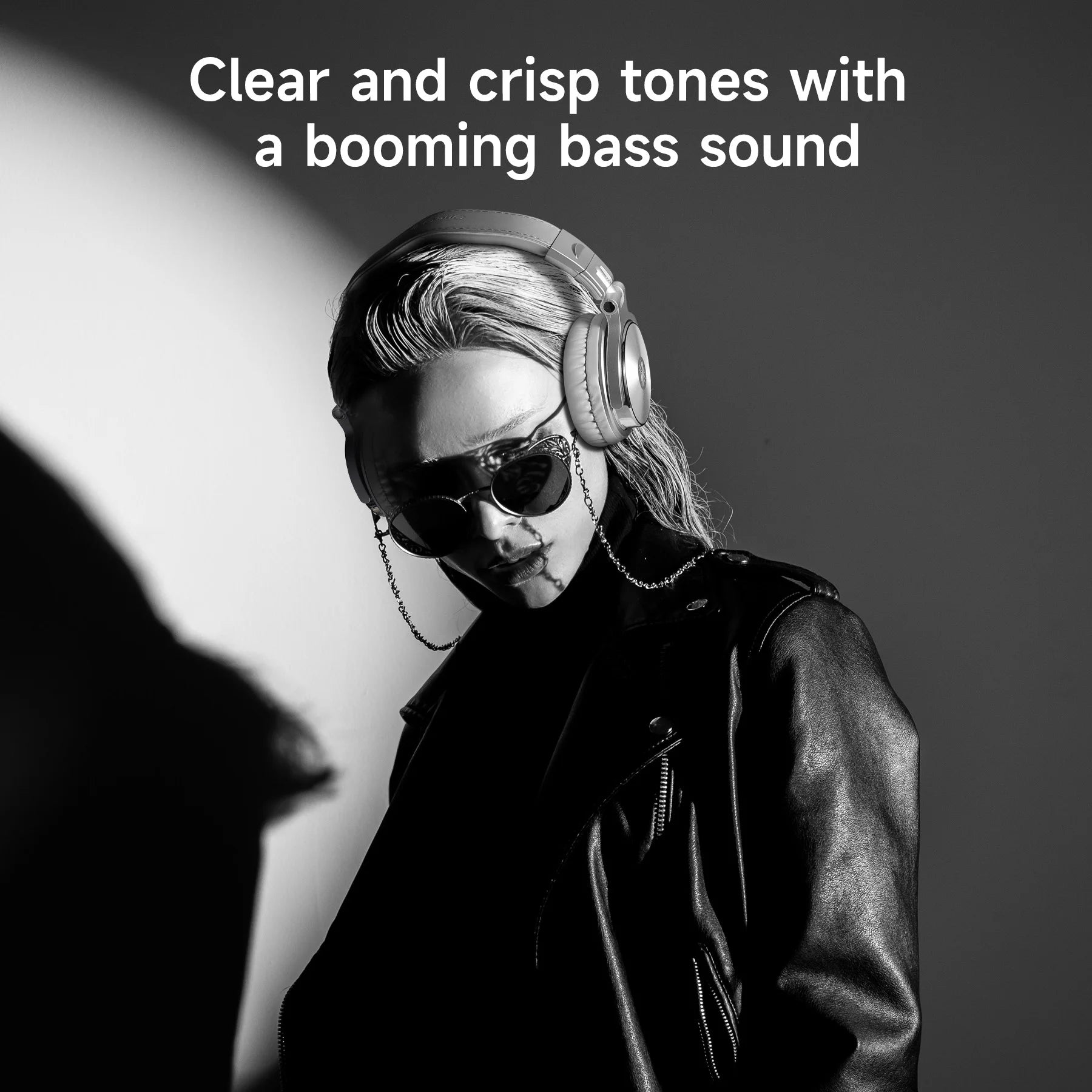 Person wearing headphones and sunglasses with text about clear tones and booming bass sound