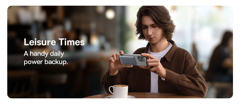 Baseus Thin Magnetic Wireless Power Bank 20W 5000mAh attached to an iPhone being used horizontally in a café setting.