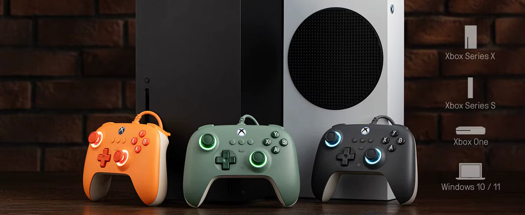 Three Xbox wireless controllers in orange, dark green, and dark gray are displayed in front of a black and white Xbox Series X S console, set against a dark brick wall background with text indicating compatibility with Xbox Series X, Xbox Series S, Xbox One, and Windows 10/11.