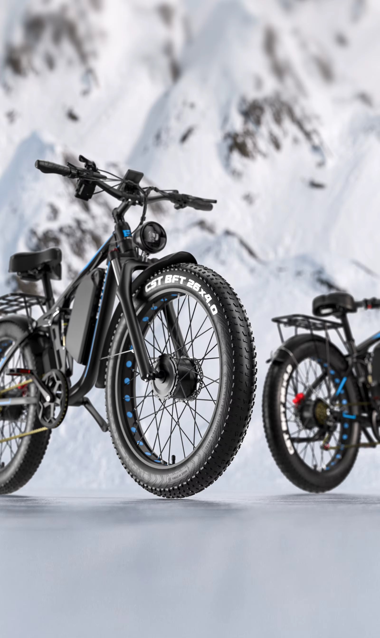 Two electric E‑BYCCO EB7Pro e-bikes on a snowy landscape with mountains in the background