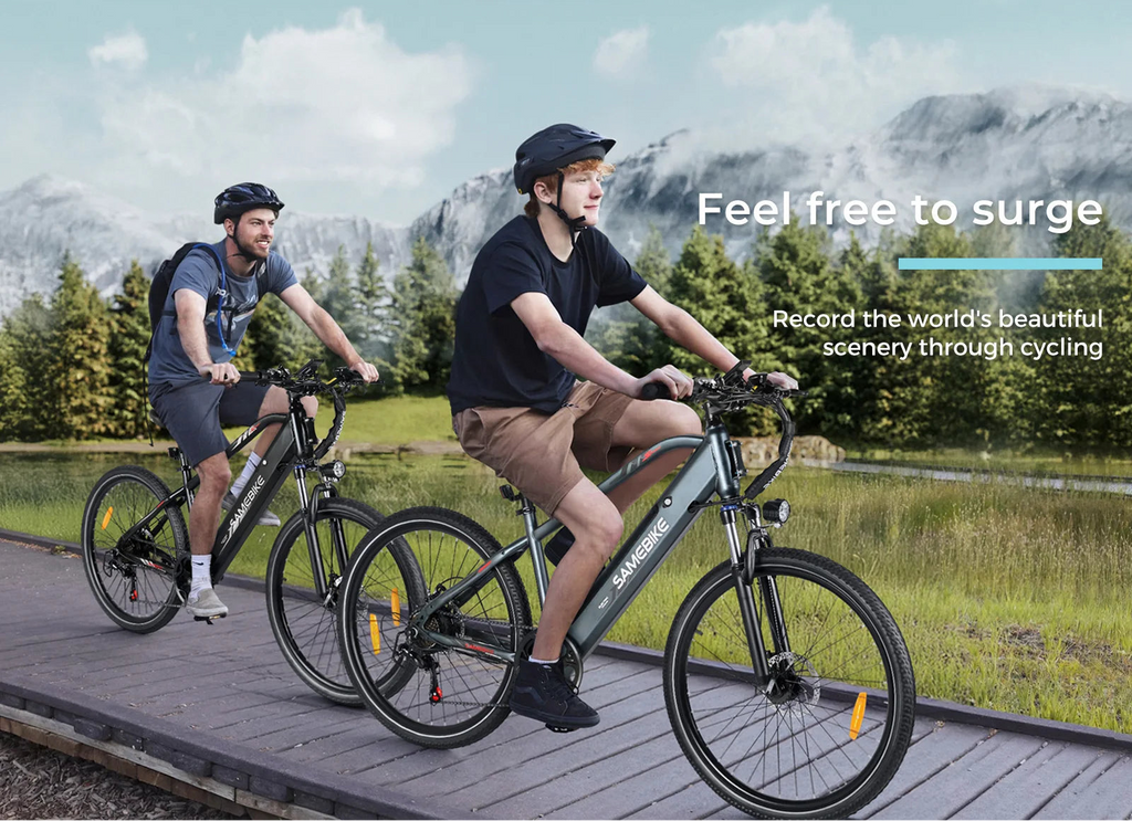 Two people riding electric SAMEBIKE RS-A01 MEN  bikes on a wooden path with mountains in the background