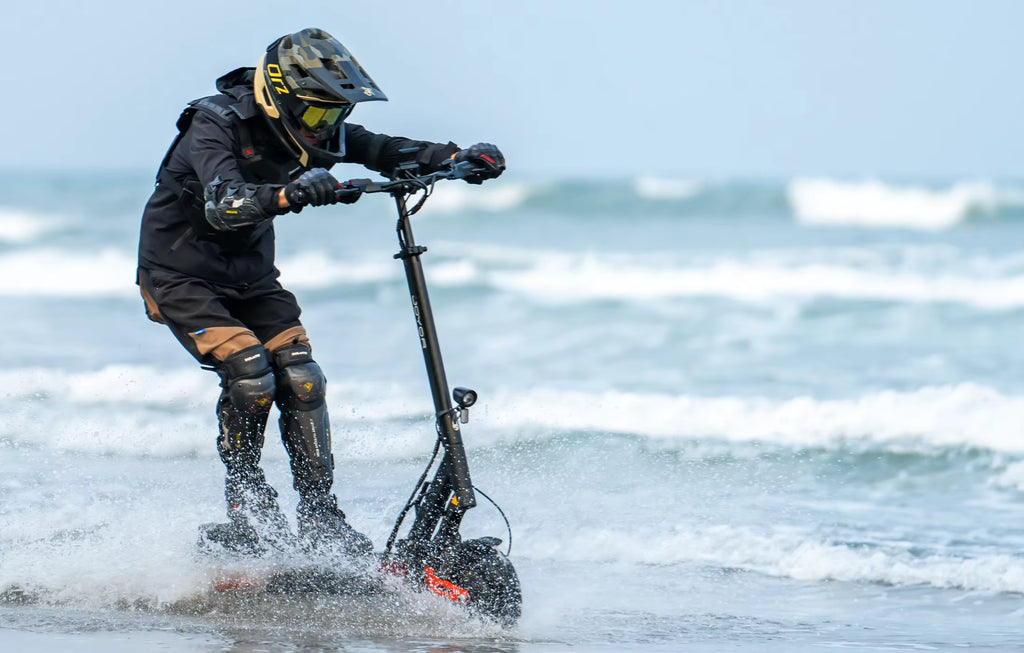 Person riding a water scooter on a beach with ocean waves in the background