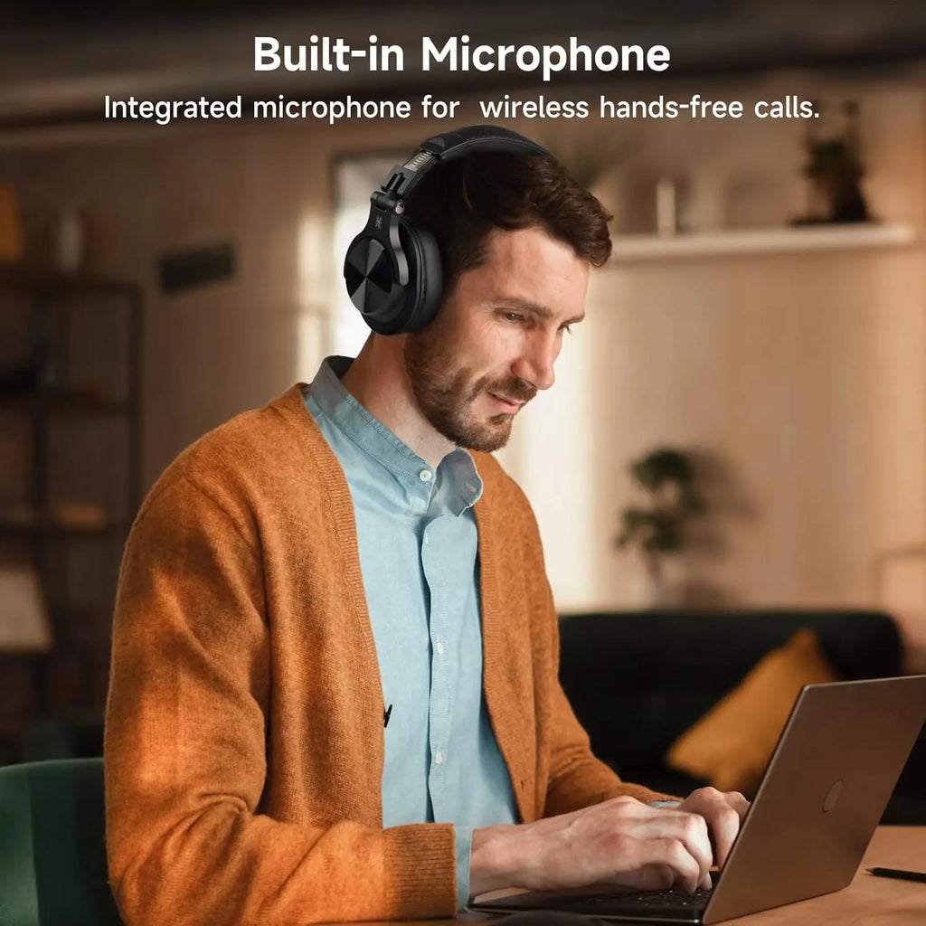 Man wearing headphones using a laptop with text about a built-in microphone.
