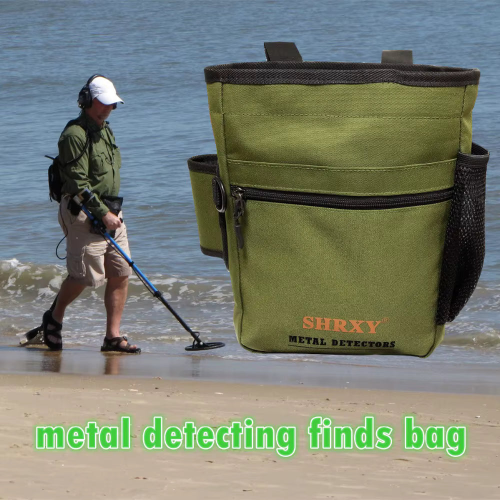 Metal detectorist using tactical finds bag on coastal sand beach while detecting