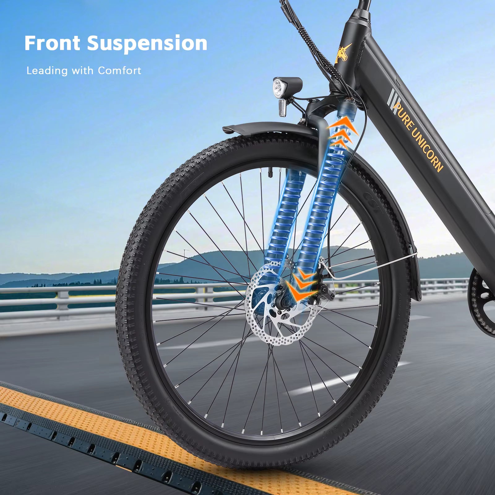 PURE UNICORN U2 Electric Bicycle with front suspension system on a road with scenic background