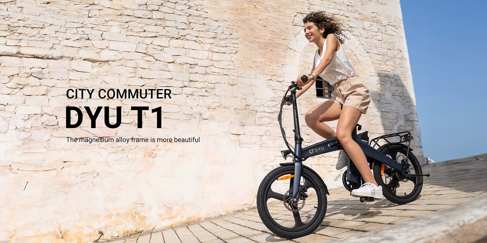 Woman riding a black electric bike against a stone wall with 'CITY COMMUTER DYUT1' text.