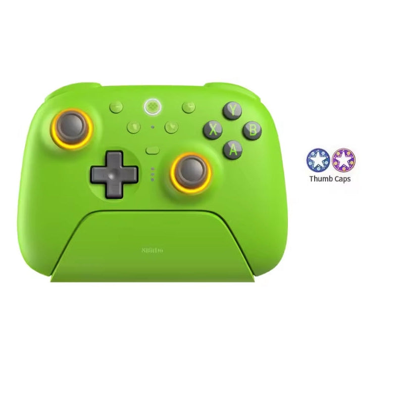 8BitDo Ultimate 2 Wireless Controller in Green docked on its magnetic charging stand, featuring RGB lighting fire rings around the TMR joysticks, action buttons, 2.4GHz wireless USB adapter, and included thumb caps.