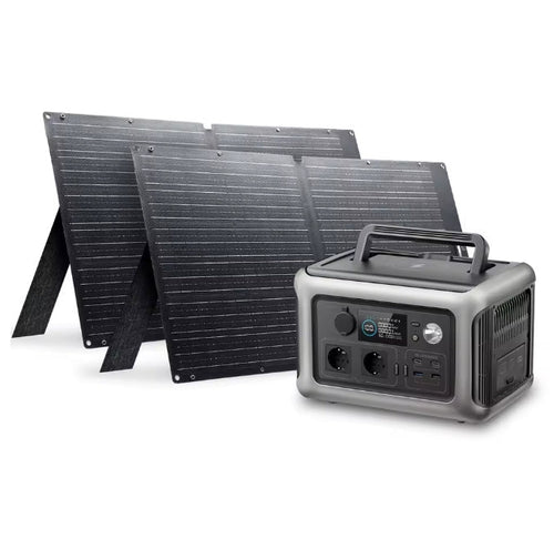 Portable power station with four foldable solar panels, shown on a clean white background. The power station has a gray and black design with multiple output ports and a carry handle, while the solar panels are dark gray/black with visible ribbed solar cells.