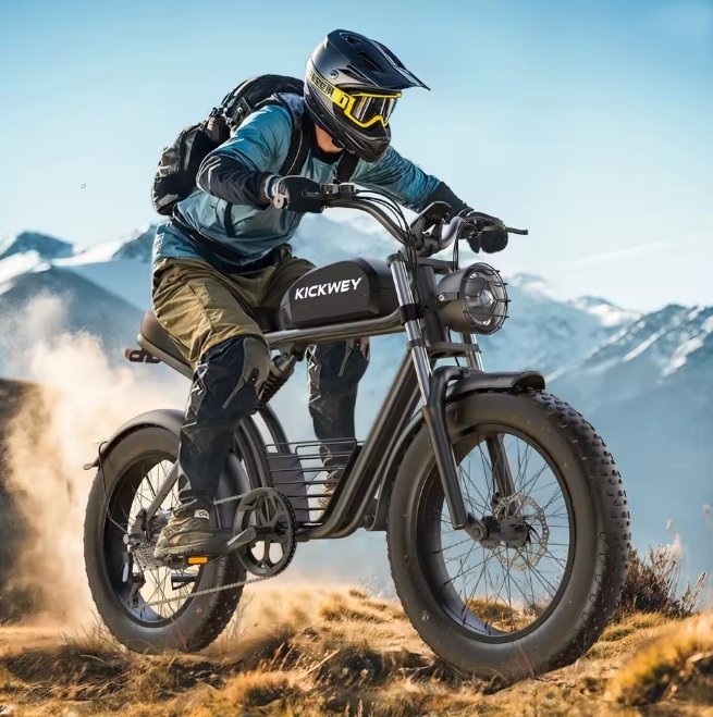 Person riding a Kickwey electric bike with full protective gear on with a backpack in a mountainous landscape