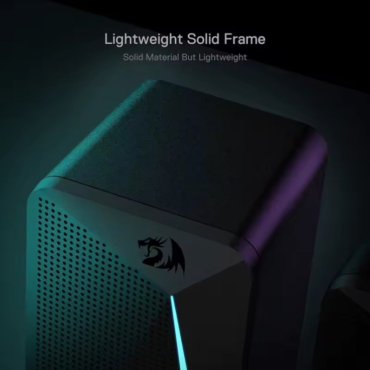 A close-up of a modern electronic RGB speaker device with a solid triangular front panel, perforated side grille, and a black dragon logo, shown in a dark setting with blue and purple lighting. Text at the top reads 'Lightweight Solid Frame' and 'Solid Material But Lightweight'.